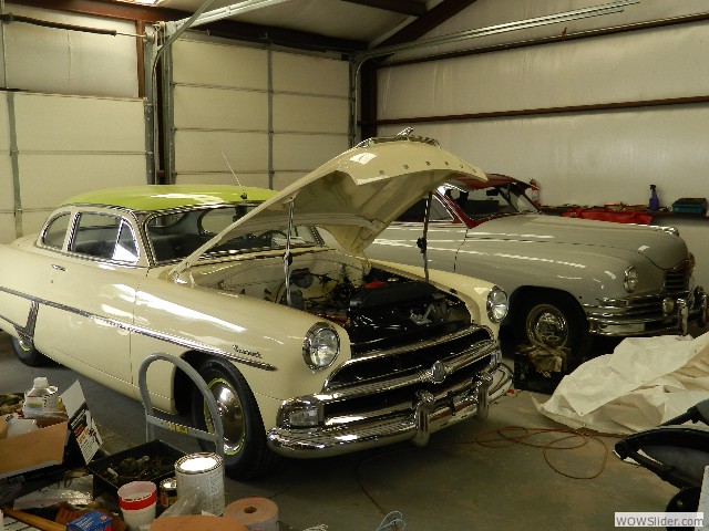 A 1954 Hudson Hornet and 1947 Packard undergoing restoration